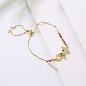 Detail view of the colorful zircon butterfly charm on a 18K gold plated slider bracelet
