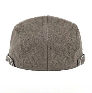 Detailed back view of cotton flat cap featuring embroidered lines and adjustable metal buckle