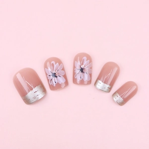Pink press-on nails with white daisy floral art and silver foil French manicure tips