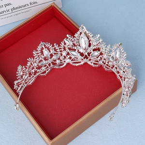 Detail view of a luxury silver bridal crown with crystals in a red jewelry gift box