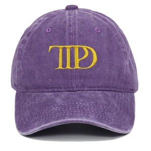 Close-up of purple washed cotton baseball cap featuring yellow TTPD 3D embroidery detail