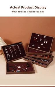 Macro shot of walnut wood jewelry trays with dark red velvet lining for various accessories