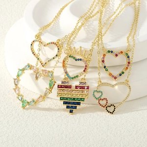 Detail of gold heart pendant necklaces with colorful zircon stones on a tray