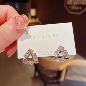 Close-up of geometric triangle earrings with 925 silver posts and micro-paved crystals