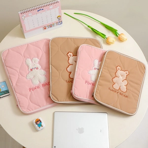 Quilted fabric tablet sleeves in pink and khaki featuring cute cartoon rabbit and bear embroidery