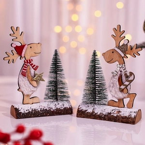 Christmas reindeer ornaments with wooden base and mini cedar trees in warm lighting