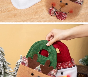 Detailed view of handmade Christmas felt gift bags featuring reindeer and snowman designs