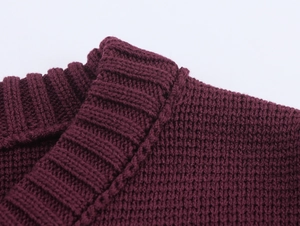 Detailed close-up of dark purple knit top featuring ribbed crew neckline texture