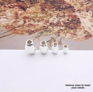 Detailed view of four sizes of S925 sterling silver drop-shaped beads for DIY jewelry