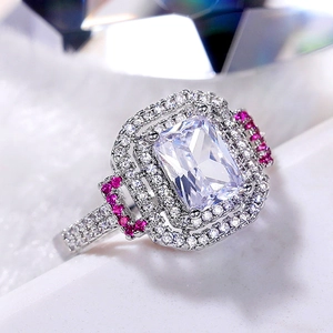 Emerald cut princess ring with pink accents and double halo in polished silver setting