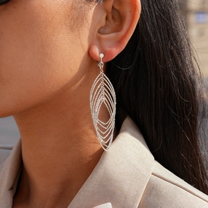 Silver geometric layered leaf earrings on model with elegant minimalist style