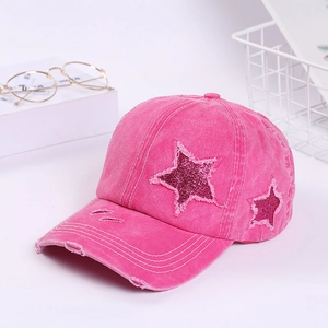 Distressed pink cotton baseball cap with glitter star patch and frayed edge detailing
