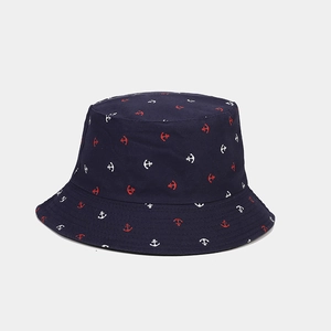 Detailed macro view of navy blue bucket hat featuring red and white anchor print patterns