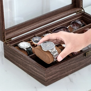 Close-up of walnut wood watch and eyewear organizer with carbon fiber PU leather finish