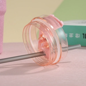 Detail view of 30oz tumbler pink lid with straw hole and clear threaded closure