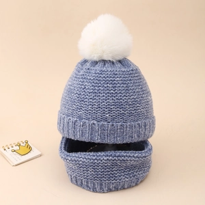 Close-up of knit baby beanie and neck warmer set in grey blue with white fluffy pompom