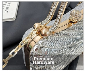 Detail of silver sequin evening bag with gold frame and sparkling diamond sphere clasp