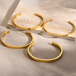 Minimalist gold stainless steel open C-shaped bangle set with polished flat surface