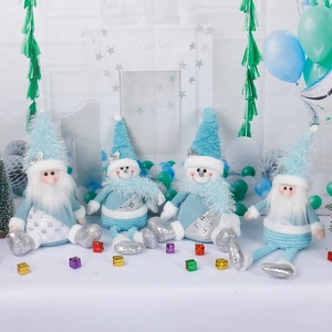 Set of four plush Christmas dolls including Santa and snowmen in light blue festive decor