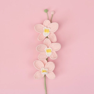 Hand-knitted orchid bouquet with 3 pink flowers and white centers on a pink background