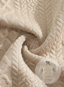 Detailed close-up of khaki jacquard knit polo fabric showing refined herringbone texture