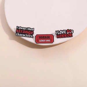 Collection of five 80s horror movie enamel pins featuring classic thriller quotes
