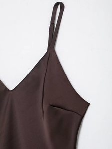 Detailed close-up of dark brown satin dress featuring adjustable thin spaghetti straps
