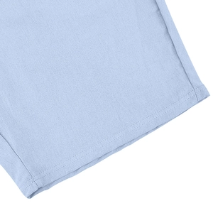 Close-up of neat stitching and breathable linen fabric texture on light blue polo shirt