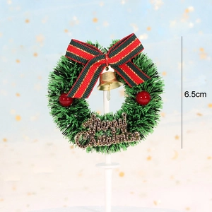 Detailed view of a green Christmas wreath cake topper with red bow and gold bell