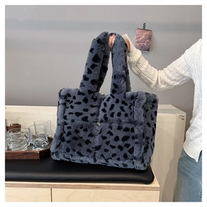 Close-up of fluffy faux fur texture on grey-blue leopard print plush tote bag