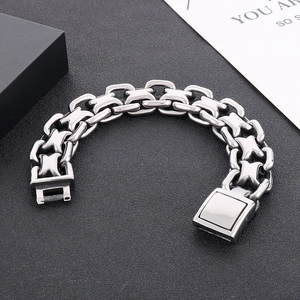 Close-up of interlocking stainless steel H-link chain bracelet with square magnetic clasp