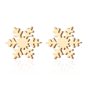 Close-up of gold snowflake stud earrings with a polished metallic finish and mirror reflection