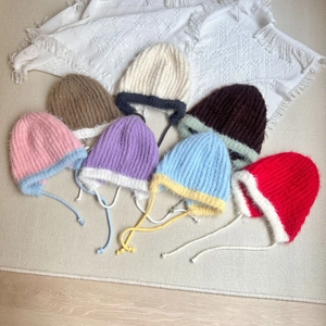 Winter plush knit earflap hats for kids in various colorful contrast designs