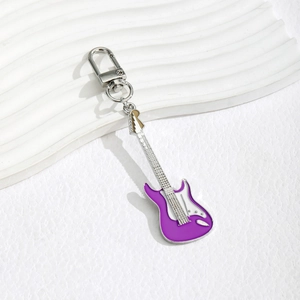 Macro view of purple enamel electric guitar keychain with silver metal lobster clasp
