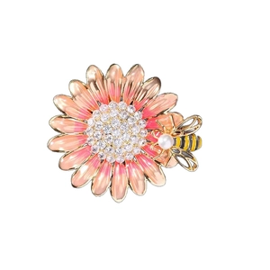 Enamel daisy brooch with a honeybee detail and sparkling rhinestone centerpiece