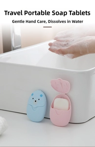 Portable bear-shaped travel soap sheets container next to a sink with soapy hand foam