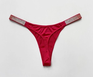 Close-up of rose red gradient thong with rhinestone straps and silky fabric texture