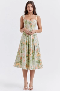 Detail showing the light green floral dress with structured bodice and side slit