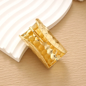 Minimalist gold alloy hair clip with honeycomb hammered texture and spring claw design