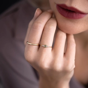 Close-up of gold S925 sterling silver opal ring set with diamonds on a model's finger