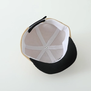 Detail view of corduroy cap interior with soft lining and adjustable strap buckle