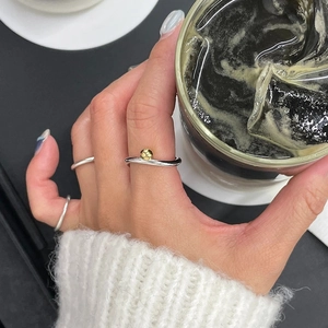 Minimalist S925 sterling silver twist ring with gold bead accent for elegant women