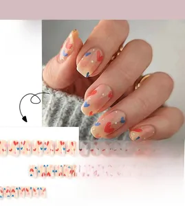 Close-up of square-oval press on nails with red and blue hearts and white polka dots