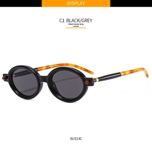 Side view of oval sunglasses featuring black frames and tortoiseshell temples with metal hinges