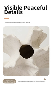 Detail of a white ceramic vase featuring a matte texture and scalloped wavy rim design