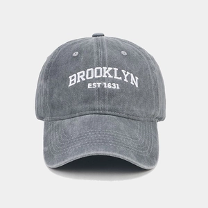 Detail view of Brooklyn embroidery on washed grey denim baseball cap for a vintage look