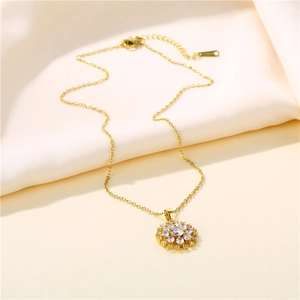 Elegant gold snowflake pendant necklace with sparkling zircon crystals on silk fabric