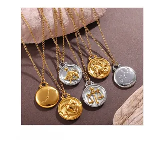 Macro shot of gold and silver zodiac relief necklaces on a textured rock surface