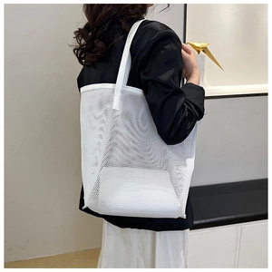 Minimalist white mesh tote bag shown on a model in a clean indoor setting