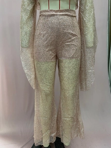 Detail of glittery sequin fabric and mesh texture on a stylish two-piece jumpsuit set